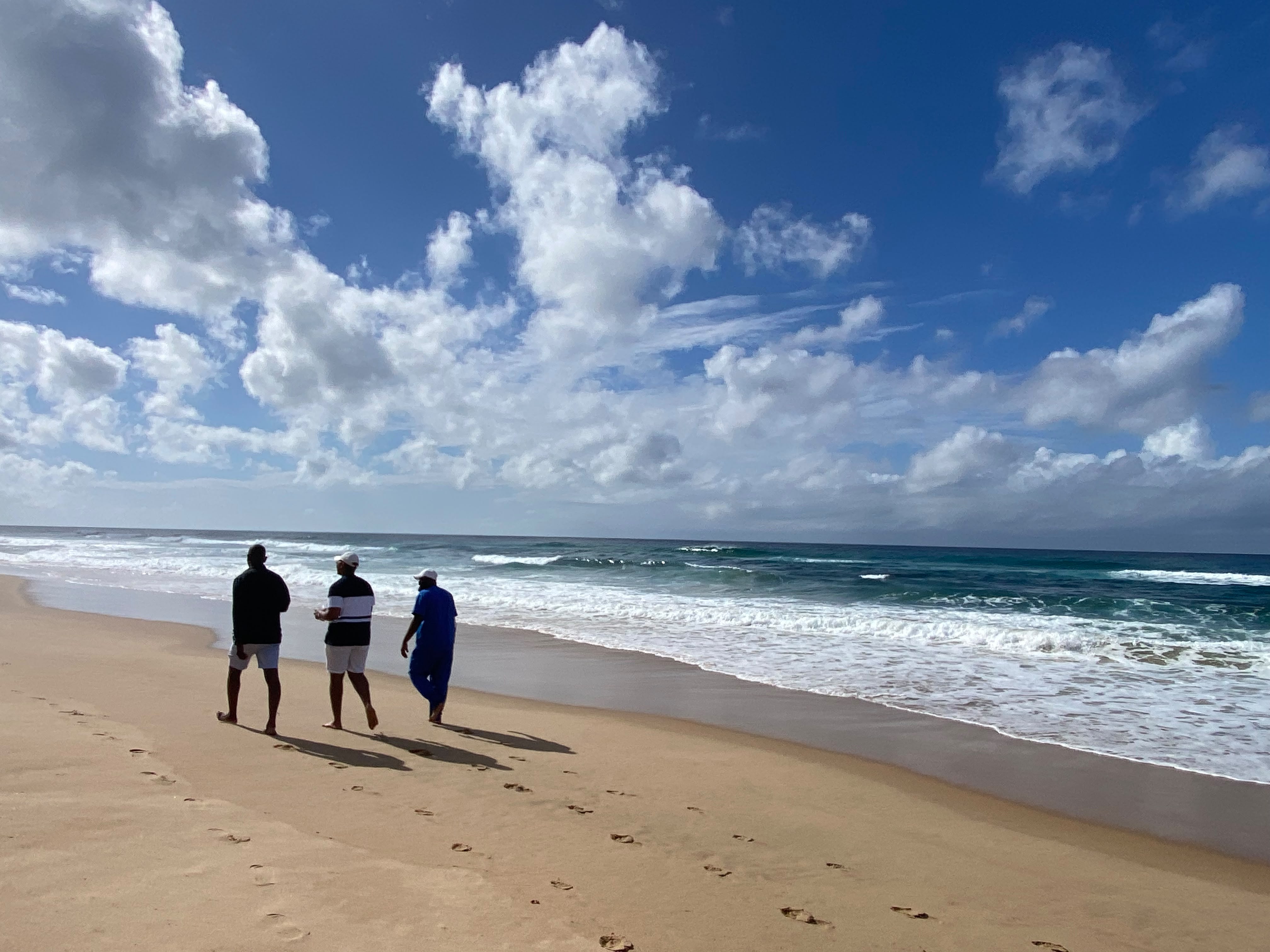 Amigos a caminhar na praia de Ponta Malongane